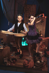Children in Halloween costumes playing on pirate ship