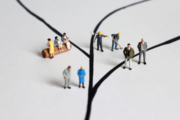 Diverse miniature people. A concept of social role conflict.