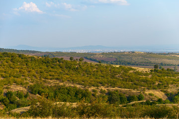 The top view on the valley among the Old Balkan Mountains. In the background are the Burgas Bay and the city of Burgas. Bulgaria.
