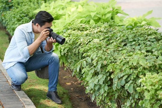 Photographer taking marco photos of camera with special lens