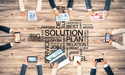 Top view of businesspeople sitting at table and using gadgets