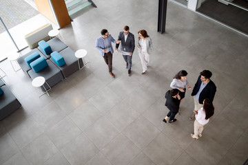 Business people working together in office hall.
