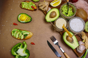 bruschetta appetizers with avocado. Bunch of raw ripe organic avocados whole. Seasonal harvest crop local produce concept. Authentic lifestyle image