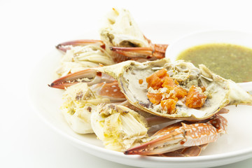 steamed crab roe and claws with seafood sauce on white background