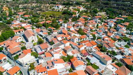 Aerial Lania (Laneia) wine village, Limassol, Cyprus. Bird's eye view of traditional Mediterranean, picturesque alleys, red ceramic roof tile houses, vineyards, church and entrance. 