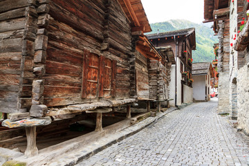 Fototapeta na wymiar Beautiful traditional wooden houses in the streets of the alpine village Grimentz, Switzerland, in the canton Valais, municipality Anniviers 