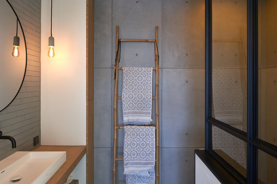 Interior of a modern apartment on the sixth floor of a new apartment building in the Houthavens area in Amsterdam. A decorative ladder with towels in the bath room.