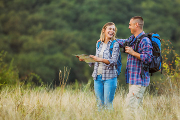 Happy couple is hiking in mountain.