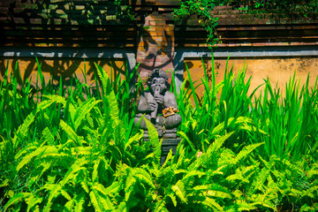 Indonesian historical statue nearby the beach of the Bali island, Indonesia. Bali is an Indonesian island and known as a tourist destination. In Bali, rice harvest seasons come three times in a year.
