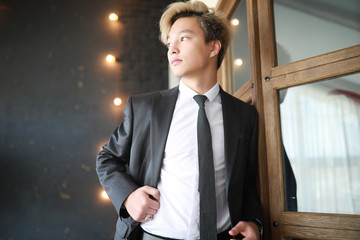 Young Asian businessman in white shirt and tie