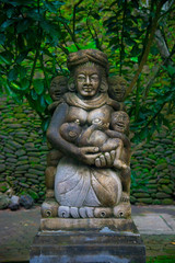 Fototapeta na wymiar Indonesian historical statue nearby the beach of the Bali island, Indonesia. Bali is an Indonesian island and known as a tourist destination. In Bali, rice harvest seasons come three times in a year.