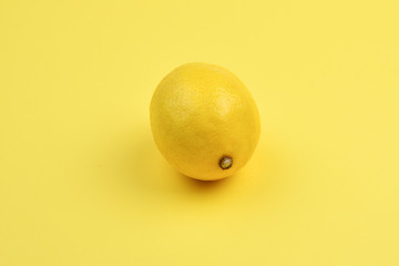 Lemon isolated on yellow background.