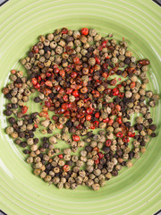Mix of peppercorns - pink, black, green in a dish