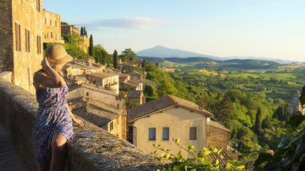 Montepulciano, Tuscany, Italy, Girl looks at the landscape of the city and countryside from the...