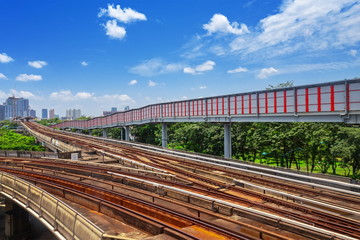 Fototapeta na wymiar Trains traveling on elevated rails of BTS Metro System Thailand, Bangkok mass rapid train (MRT) travels on the track.