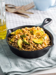 Buckwheat with zucchini and turmeric in cast iron skillet. Easy and healthy lunch for celiac gluten free diet