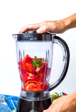 Man Using Blender To Make A Tomato Smoothie