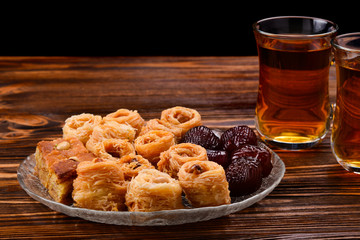 Tea with rahat and dried fruits on a wooden table