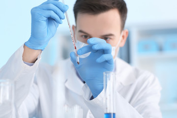 Scientist working with blood sample in laboratory