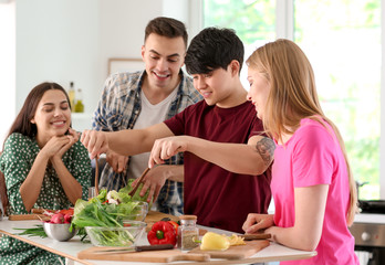 Friends cooking together in kitchen