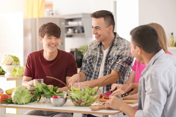 Friends cooking together in kitchen