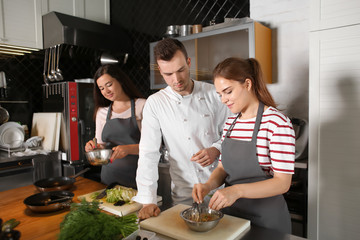 Chef and group of young people during cooking classes