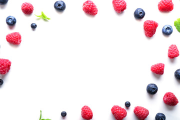 Delicious ripe berries on white background, top view