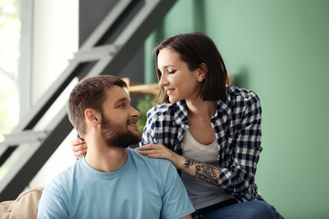 Happy lovely couple resting at home