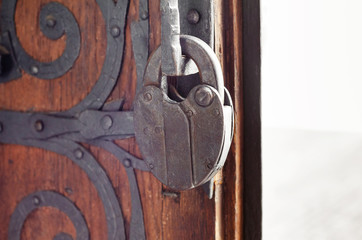 Large metal lock on the ancient door of the Catholic church