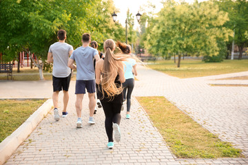 Obraz premium Group of sporty people running outdoors