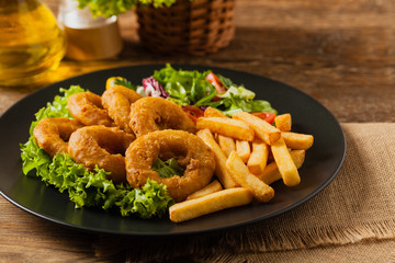 Roasted squid rings with fries.