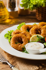 Roasted squid rings with salad.