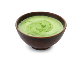 Tasty zucchini soup in bowl on white background