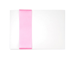 Paper card with pink ribbon on white background
