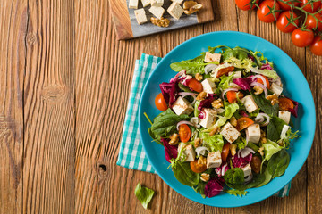 Delicious salad with tofu, tomatoes and walnuts.