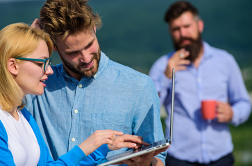 Couple works despite of coffee break. Colleagues with laptop work outdoor sunny day, nature...