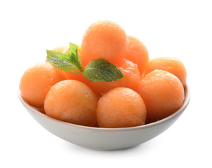 Bowl with delicious melon balls on white background