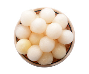 Bowl with delicious melon balls on white background