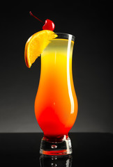 Fresh summer cocktail in glass on dark background