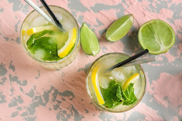 Glasses of fresh mojito on light table