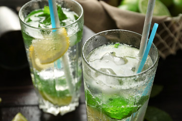 Glasses of fresh mojito on table, closeup
