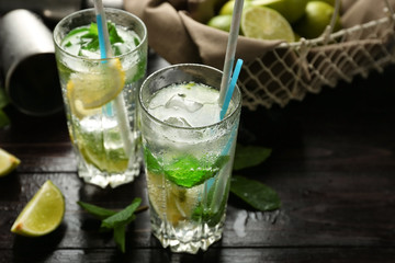 Glasses of fresh mojito on wooden table