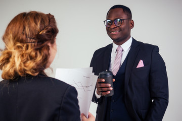 beautiful and young indian woman journalist interviews by African american bank manager owner ceo business man in the studio on a white background