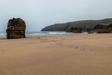 Fototapeta na wymiar Sango Sands, Durness Beach, Scotland with dog footsteps in the sand