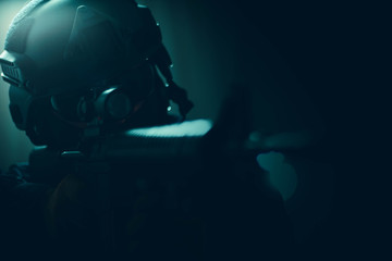 Group of security forces in Combat Uniforms with rifles, lined in the face of danger. Studio...