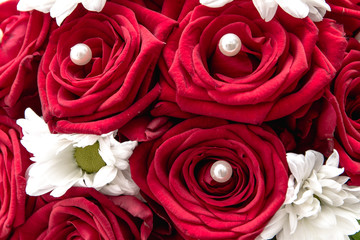 Wedding bouquet made of red roses and pearls isolated on a white background