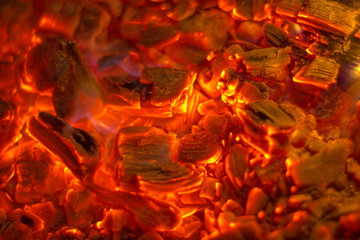 Glowing charcoal close-up pieces briquettes background
