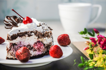 Slice of cake with cherries and strawberries