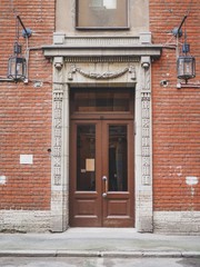 The door of the historic building with sculptures in St. Petersburg, a house, the entrance of the house