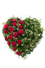 Funeral wreath - ikebana in a shape of the heart isolated on a white background